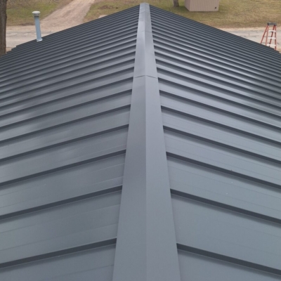 High-quality metal roof installation in Kalkaska, Michigan, utilizing Charcoal color 22ga Standing Seam Steel, demonstrating expert craftsmanship and durability for Michigan metal roofing.
