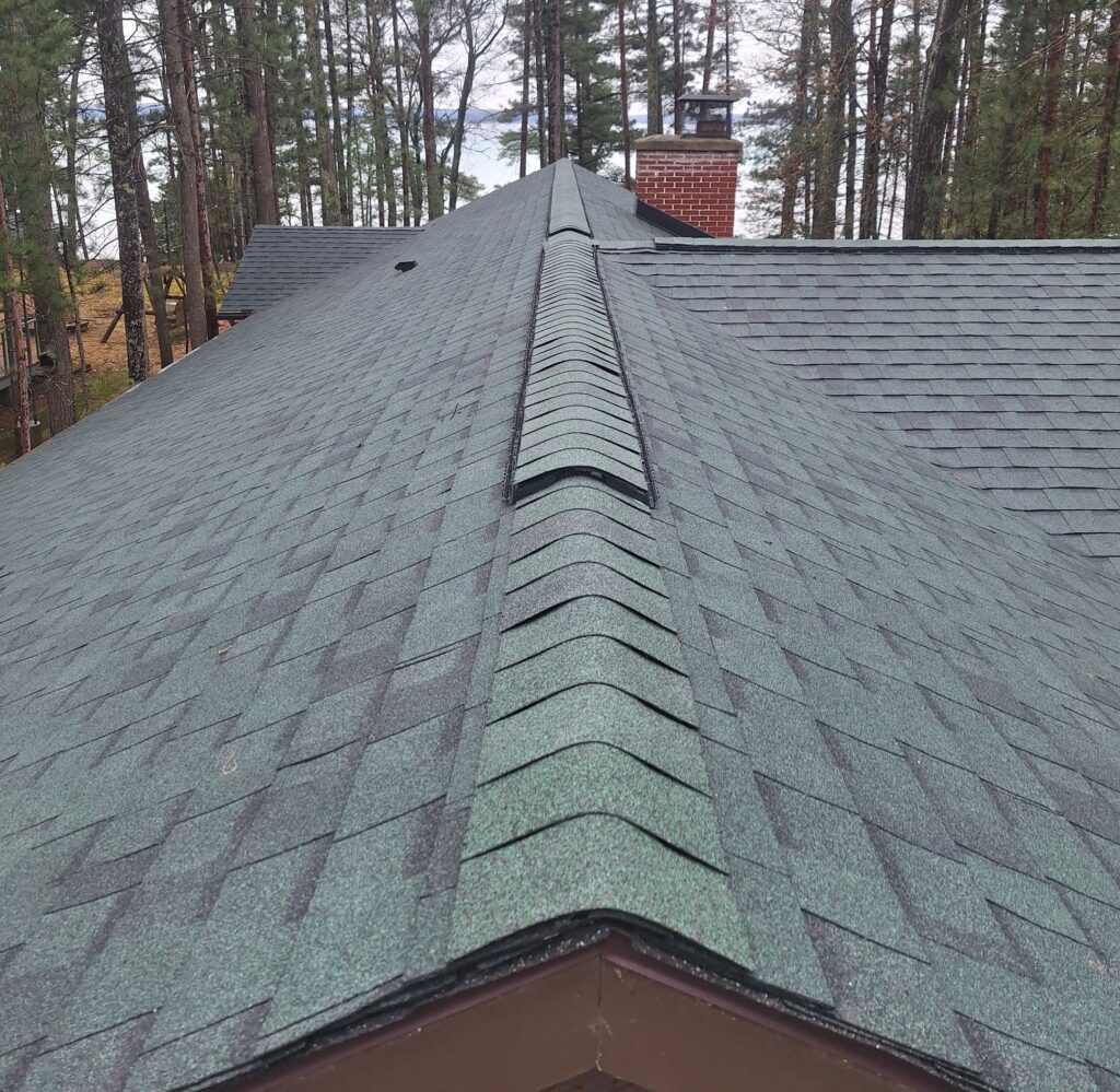 Completed Michigan roofing project in Roscommon, featuring Atlas Pinnacle Pristine Shingles in Woodland Green on a residential home, showcasing the enhanced look and durability.
